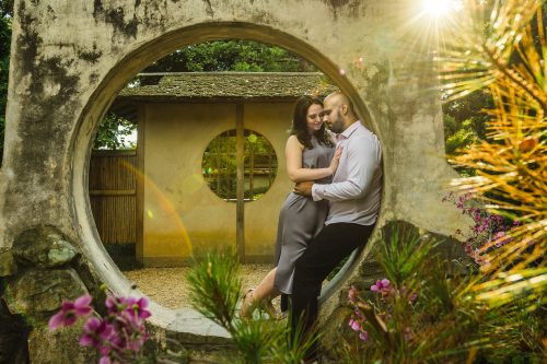 couple intimate at garden art feature in piedmont park atlanta sun flare