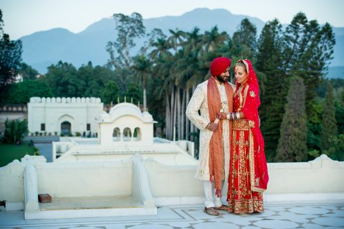 couple portrait on rooftop of ancient 17th century building front of Himalayas