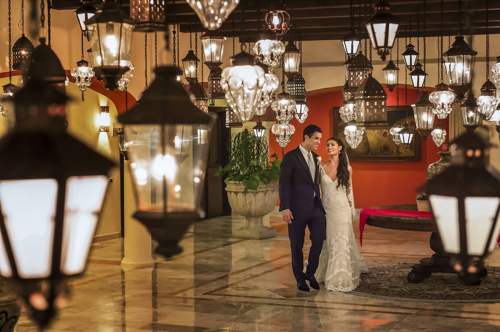 bride and groom walking through lantern room in cancun mexico